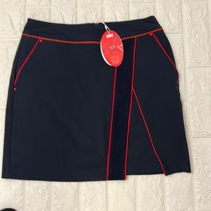 Greg Norman size 2 skort navy blue w/red strip.  NWT
